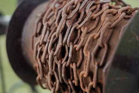 The element of the well is a chain. Old well in a village. Stock Photos