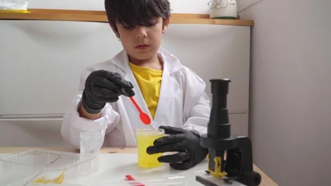 Elementary age boy shaking a chemical compound Stock Footage 280684829