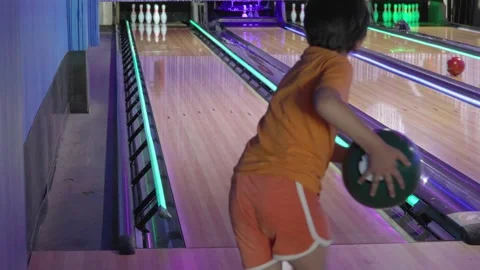 Elementary age boythrowing a bowling ball Stock Footage 285435720