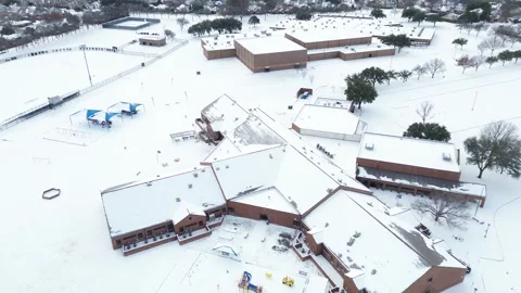 Elementary and middle school complex buildings show snow-dusted rooftops Stock Footage 327614343