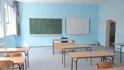 Elementary class room with desks and chairs.  Empty classroom in a school. Stock Footage 334156376