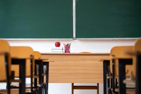 Elementary classroom, no kid or teacher, with chairs and tables. Education co Stock Photos