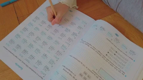 Elementary Mathematics Study Session: Child Writing Addition Problems in Stock Footage 327608360