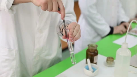 Elementary or high school kids experimenting with test tubes in chemistry class Stock Footage 55300822