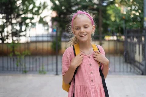 Elementary school backdrop for the barbie pink-dressed junior schoolgirl with a Stock Photos