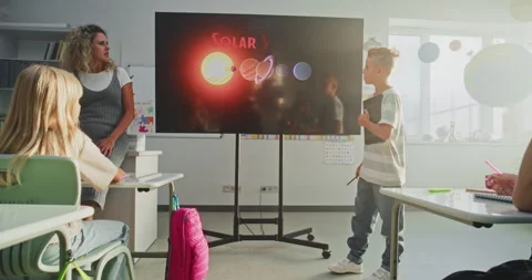 Elementary School Boy Giving Presentation About Solar System and Planets Using Stock Footage 315536555