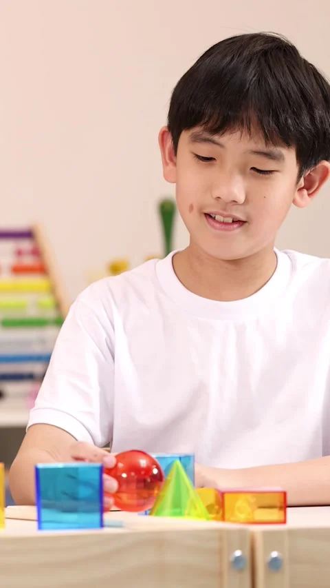 Elementary School Boy Learning Geometry With Colorful 3D Shapes Stock Footage 324934359
