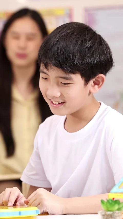 Elementary School Boy Learning Time with Classroom Clock Toy Stock Footage 330694919