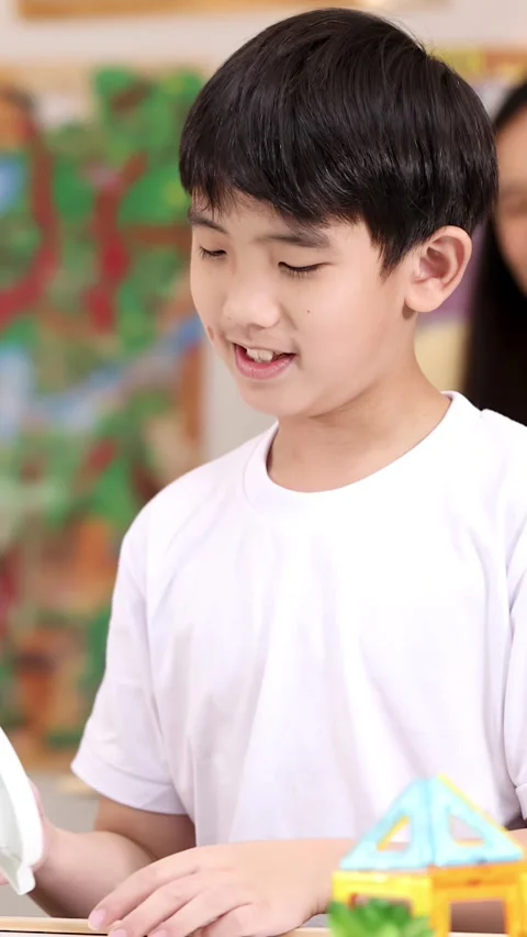 Elementary school boy learning time with classroom clock toy Stock Footage 330694931