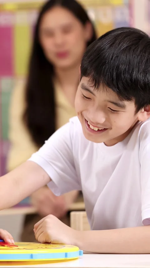 Elementary School Boy Learning Time with Toy Clock Stock Footage 330694933