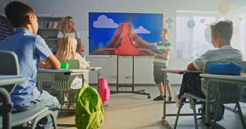 Elementary School Boy Presenting Homework, Explaining Volcanic Eruption Process Stock Photos