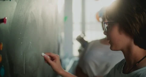 Elementary School Boy Solving Mathematical Problems Writing on the Chalkboard Stock Footage 313734057