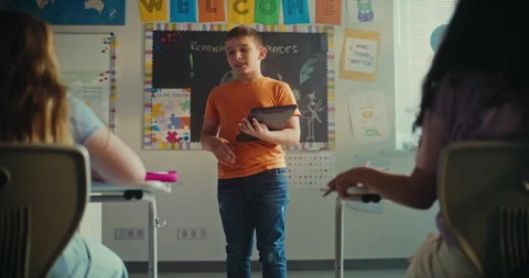 Elementary School Boy with Tablet Computer Presenting Homework on Ecology in Stock Footage 313960362