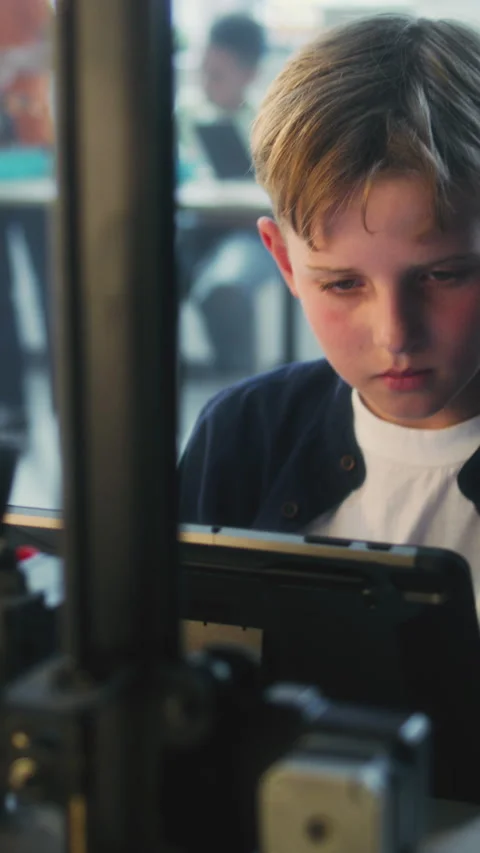 Elementary School Boy Writing Code for Advanced 3D Printer on Tablet Computer Stock Footage 311804895
