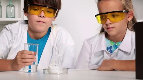 Elementary school chemistry class with experimenting kids Stock Footage 69765811