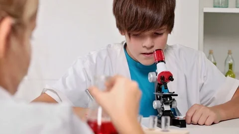 Elementary school chemistry class - kids experimenting Stock Footage 72178162