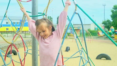 Elementary school child climbing on the school playground Stock Footage 278052840