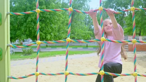 Elementary school child climbing on the school playground Stock Footage 278224665