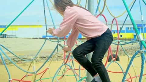 Elementary school child climbing on the school playground Stock Footage 279073005