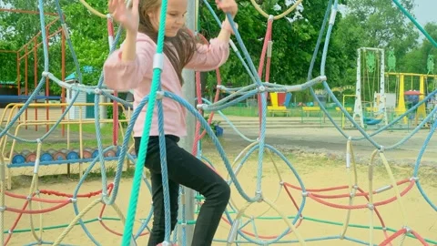 Elementary school child climbing on the school playground Stock Footage 279317392