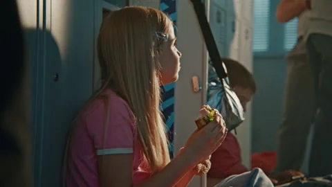 Elementary School Child Enjoying Packed Fresh Lunch While Sitting Comfortably in Stock Footage 342025738