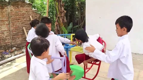 Elementary school children with special needs while playing at their school Stock Footage 293227919