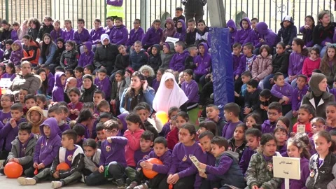 Elementary school children in yard with teachers during rocket attack drill Видео 135359692