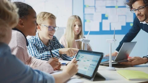 Elementary School Classroom: Teacher Holding Tablet Computer Showing to Children Stock Footage 119445339