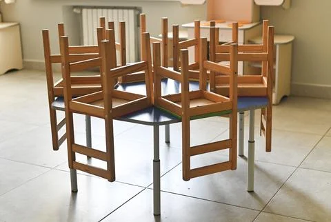 Elementary school classroom with tiny chairs on colorful desks, Stock Photos