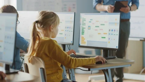 Elementary School Computer Science Classroom: Cute Little Girl Uses PC Stock Footage 119359617
