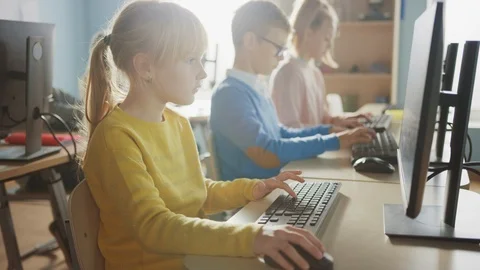 Elementary School Computer Science Classroom: Cute Little Girl Uses PC Stock Footage 119359624