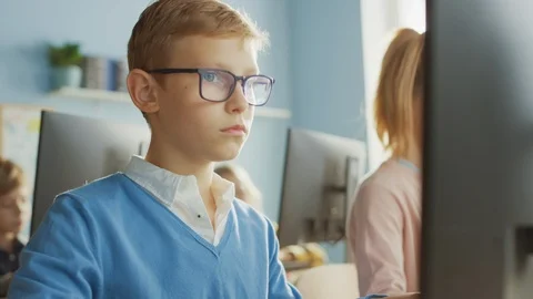 Elementary School Computer Science Classroom: Portrait of a Smart Boy Using PC 스톡 동영상 119359904