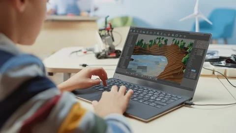 Elementary School Computer Science Classroom: Kid Using Laptop to Design 3D Game 스톡 동영상 119561227