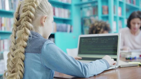 Elementary school girl coding on laptop computer Stock Footage 108748334