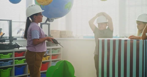 Elementary School Girl Giving Instructions for Urban Planning. Classroom STEM Stock Footage 314786363