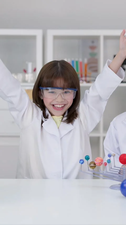 Elementary School Girl in Lab Coat Cheering in Science Class Stock Footage 341074143