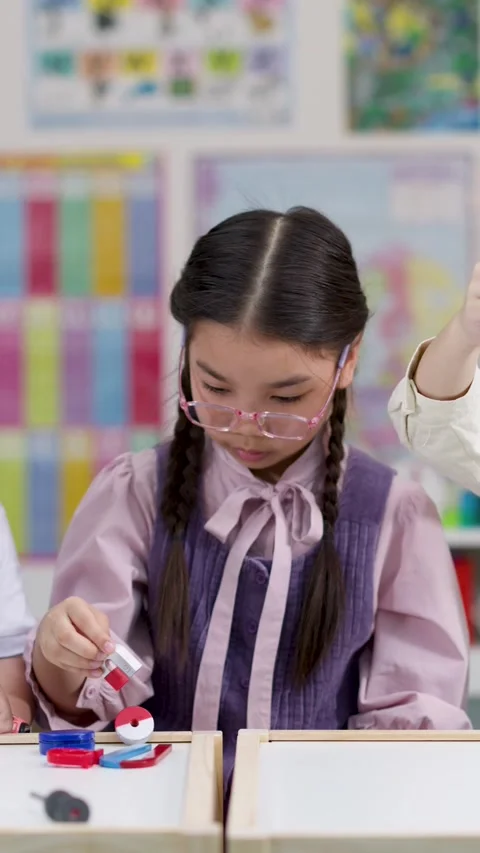 Elementary School Girl Learning Magnet Science in Classroom Stock Footage 329612065