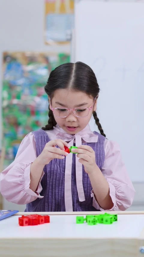 Elementary School Girl Solving Math with Colorful Counting Blocks Video stock 325164950