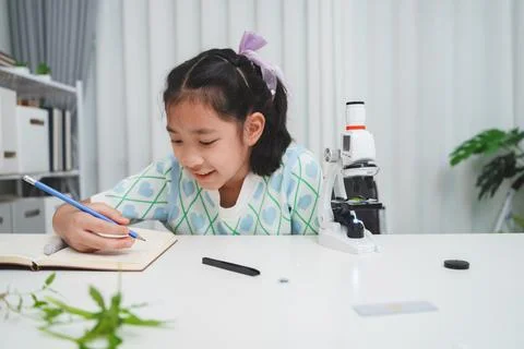 Elementary School Girl Taking Notes Science Experiment Microscope STEM Resear Stock Photos