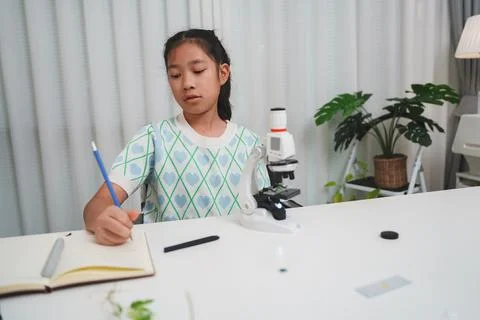 Elementary School Girl Taking Notes Science Experiment Microscope STEM Resear Stock Photos
