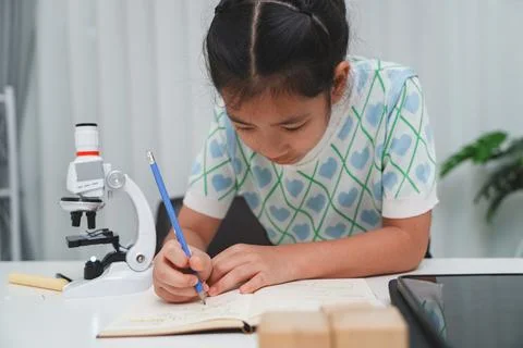 Elementary School Girl Taking Notes Science Experiment Microscope STEM Resear Stock Photos