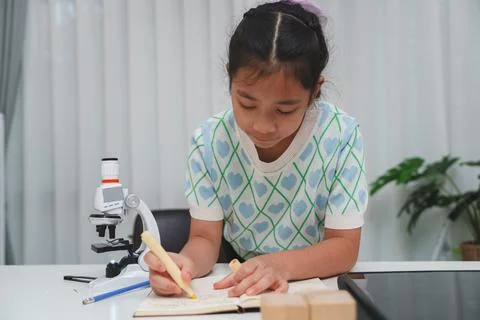Elementary School Girl Taking Notes Science Experiment Microscope STEM Resear Stock Photos