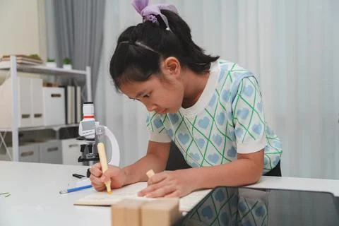 Elementary School Girl Taking Notes Science Experiment Microscope STEM Resear Stock Photos