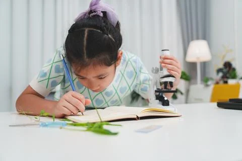 Elementary School Girl Taking Notes Science Experiment Microscope STEM Resear Stock Photos