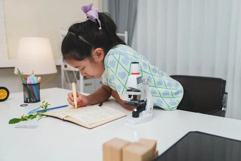 Elementary School Girl Taking Notes Science Experiment Microscope STEM Resear Stock Photos