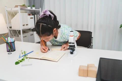 Elementary School Girl Taking Notes Science Experiment Microscope STEM Resear Stock Photos