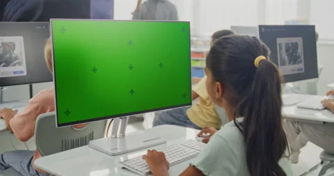 Elementary School Girl Using Computer with Green Screen During Digital Art 動画素材 316297448