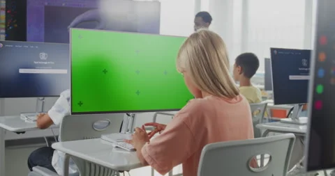 Elementary School Girl Using Computer with Green Screen Mockup, Studying Digital Stock Footage 316299095