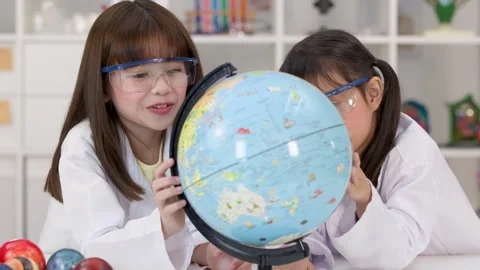Elementary School Girls in Lab Coats Studying World Globe Stock Footage 341917281