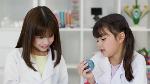 Elementary School Girls in Lab Coats Studying Solar System Model Stock Footage 342313273